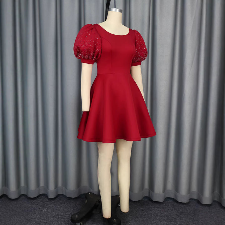 Women's cocktail dress with voluminous puff sleeves and shimmering accents StylebySassy