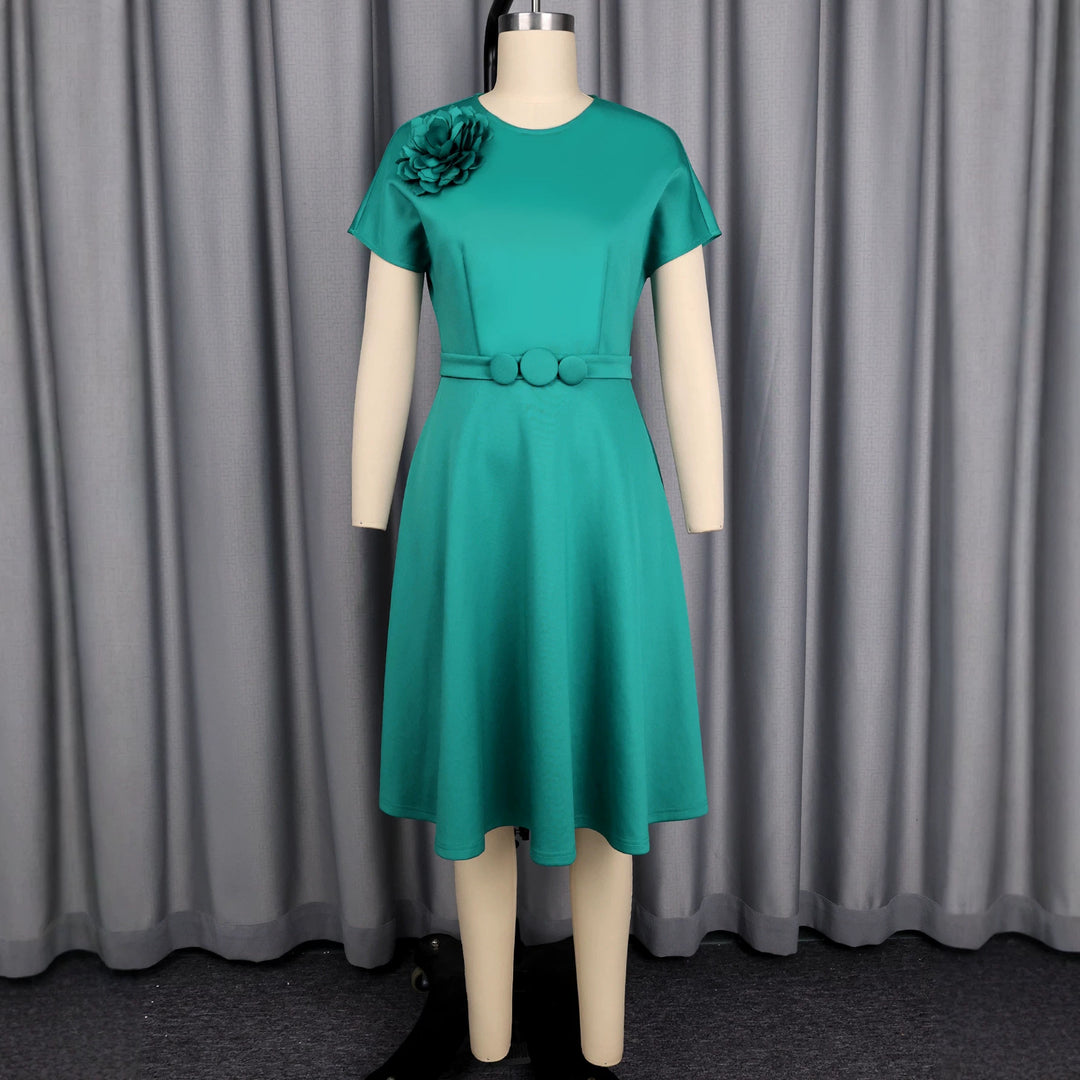 Women's dress with elegant belt and decorative flower accent StylebySassy