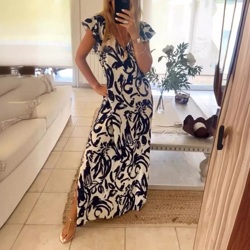 Women's flowing maxi dress with V-neck, flutter sleeves, and side leg slit StylebySassy