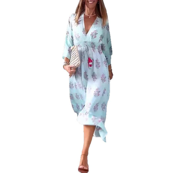 Women’s airy-flowing Boho midi dress with V-neck, gathered smock waist, drawstring with tassels, and asymmetrical ruffled hem StylebySassy