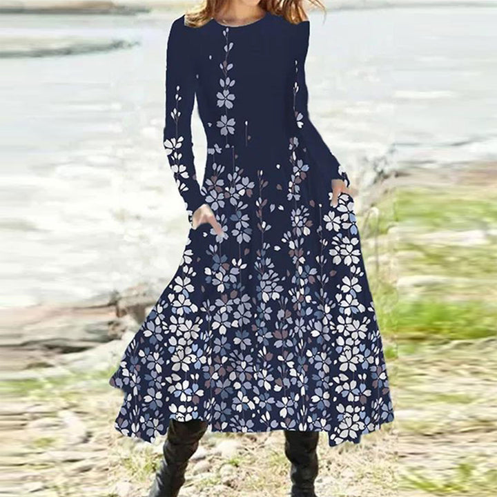Women's flowing maxi dress with tie-dye circle pattern, round neckline, waist seam, and side pockets StylebySassy