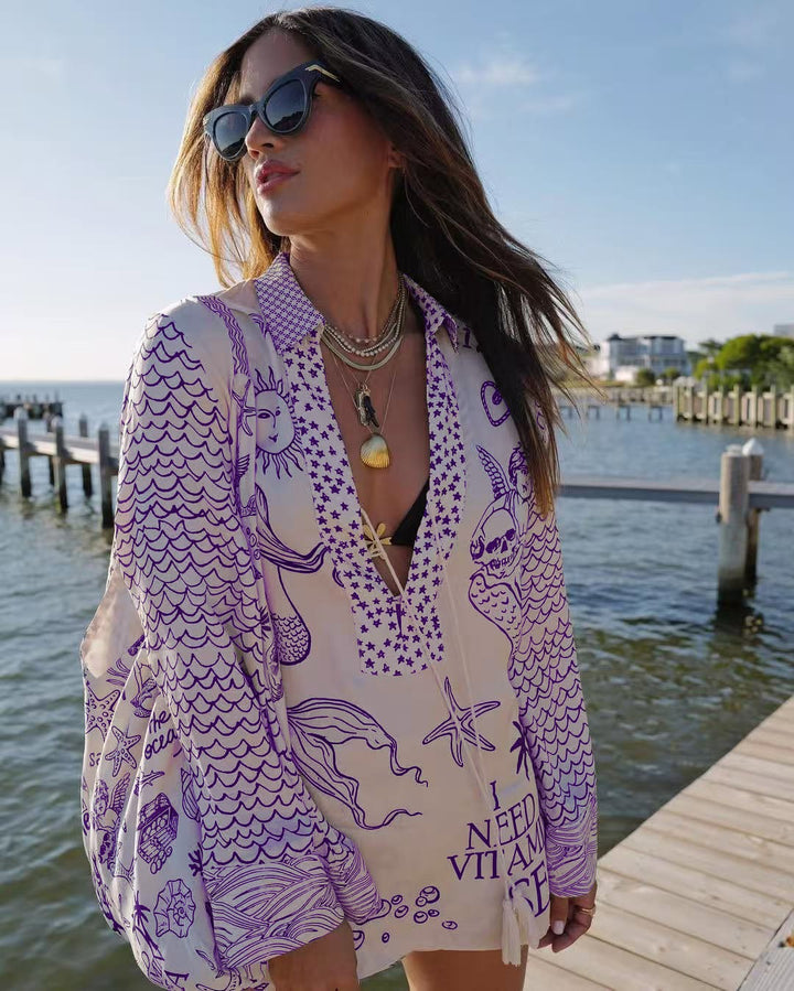 Ladies lightweight beach cover-up in tunic form with deep V-neck, tassel closure, and nautical ocean print StylebySassy