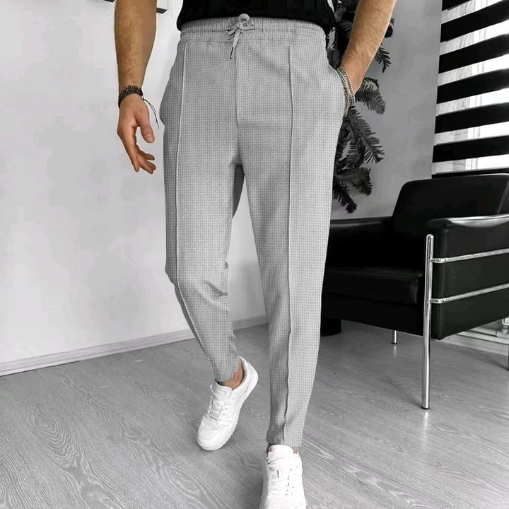 Men's tapered jogging chinos made of structured woven quality with elastic drawstring waistband and decorative crease StylebySassy