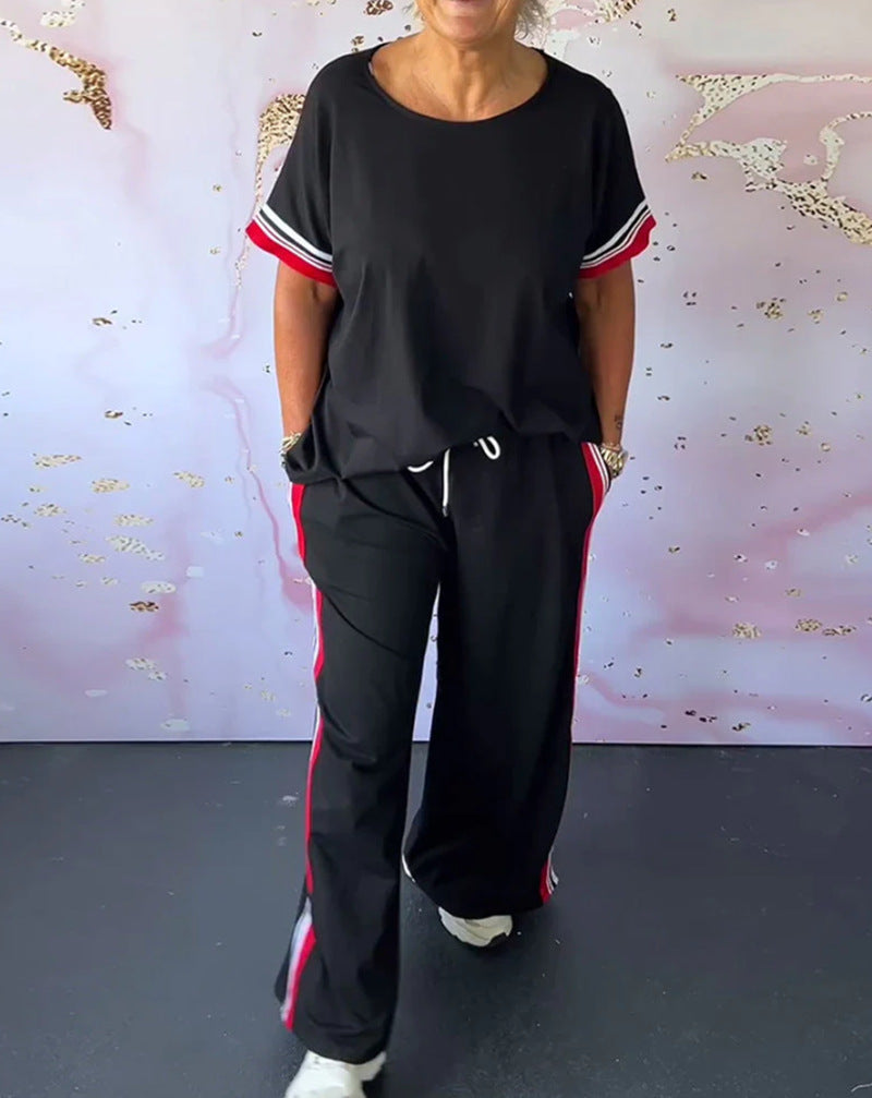 Ladies' sporty-elegant two-piece set with boxy short sleeve shirt, drawstring jog pants, and side contrast stripe StylebySassy