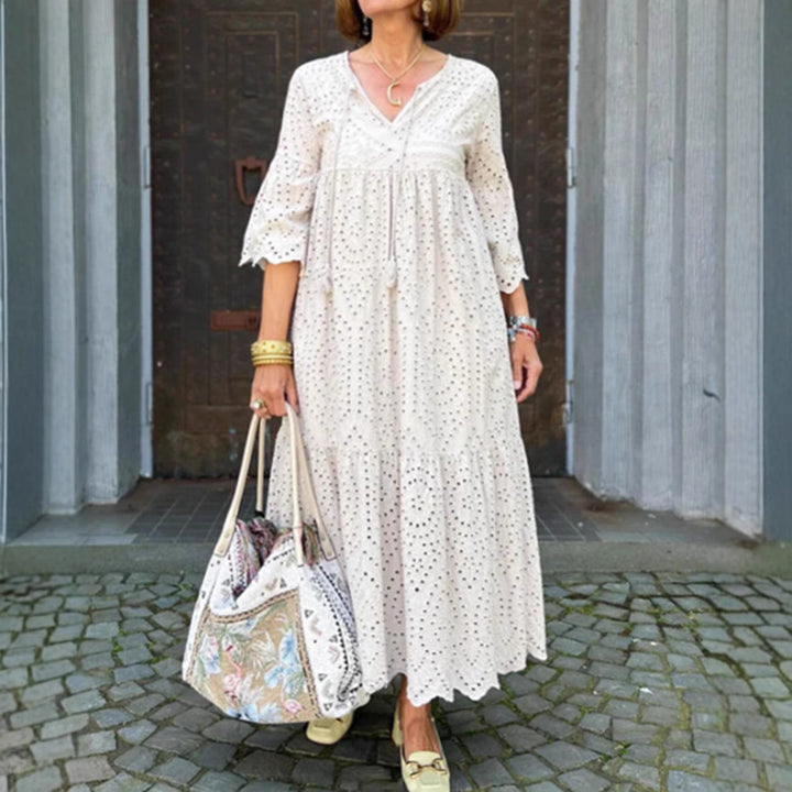 Women's flowing maxi dress with openwork embroidery, V-neck, underbust seam, and ruffled skirt StylebySassy