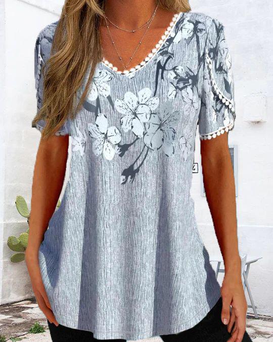 Women's nan legeres V-neck tunic shirt with floral pattern and pompom trim StylebySassy