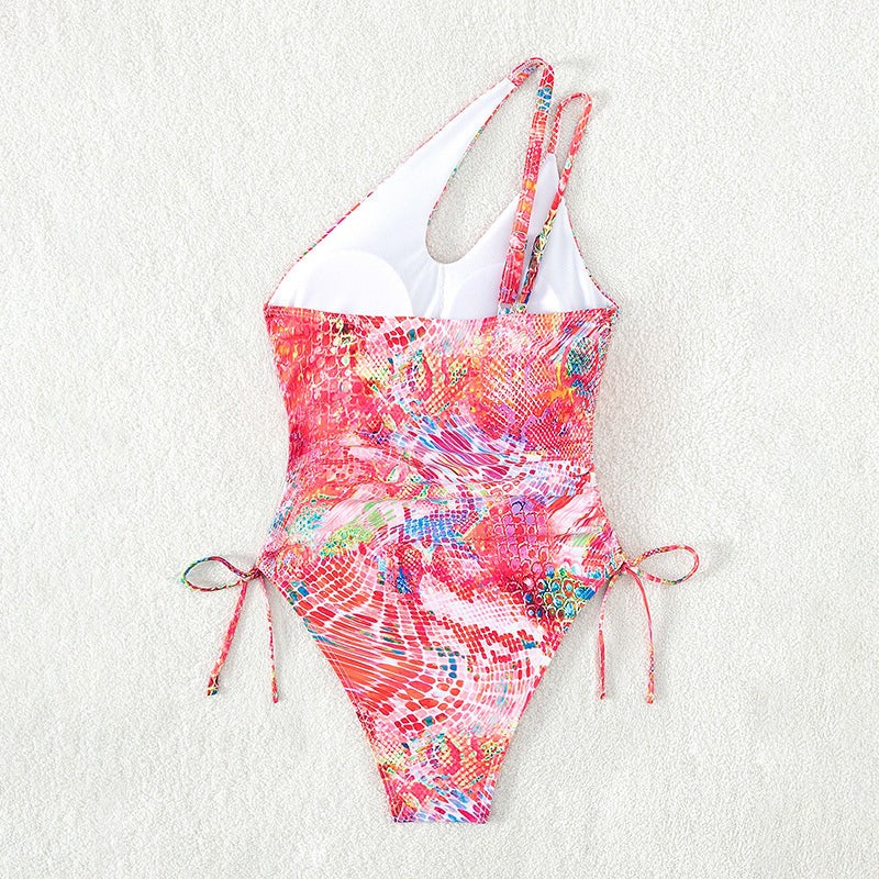 Women's one-sided swimsuit with sophisticated cut-out and vibrant pattern StylebySassy