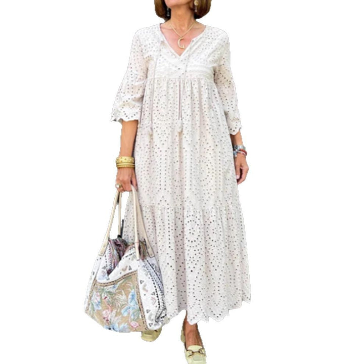 Women's flowing maxi dress with openwork embroidery, V-neck, underbust seam, and ruffled skirt StylebySassy