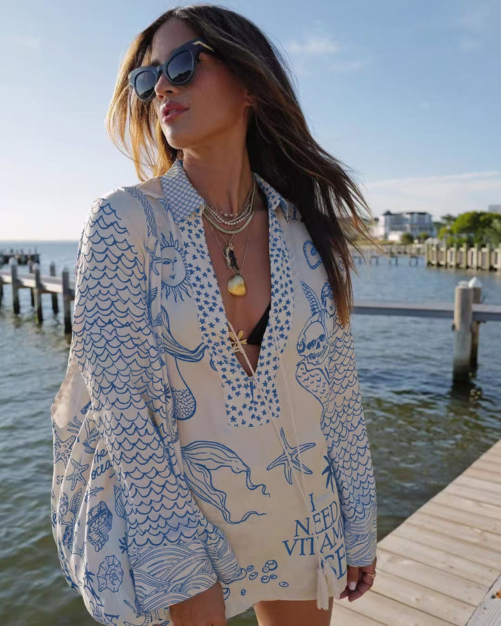 Ladies lightweight beach cover-up in tunic form with deep V-neck, tassel closure, and nautical ocean print StylebySassy
