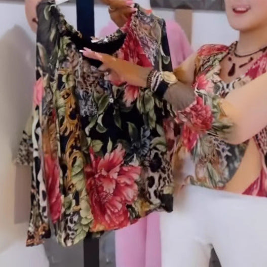 Women's light satin blouse with animal and floral print, ruffled collar, V-neck and cuffed sleeves StylebySassy