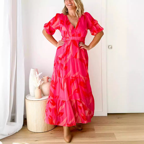 Ladies' flared maxi dress with V-neck, elastic underbust seam, and tiered skirt StylebySassy