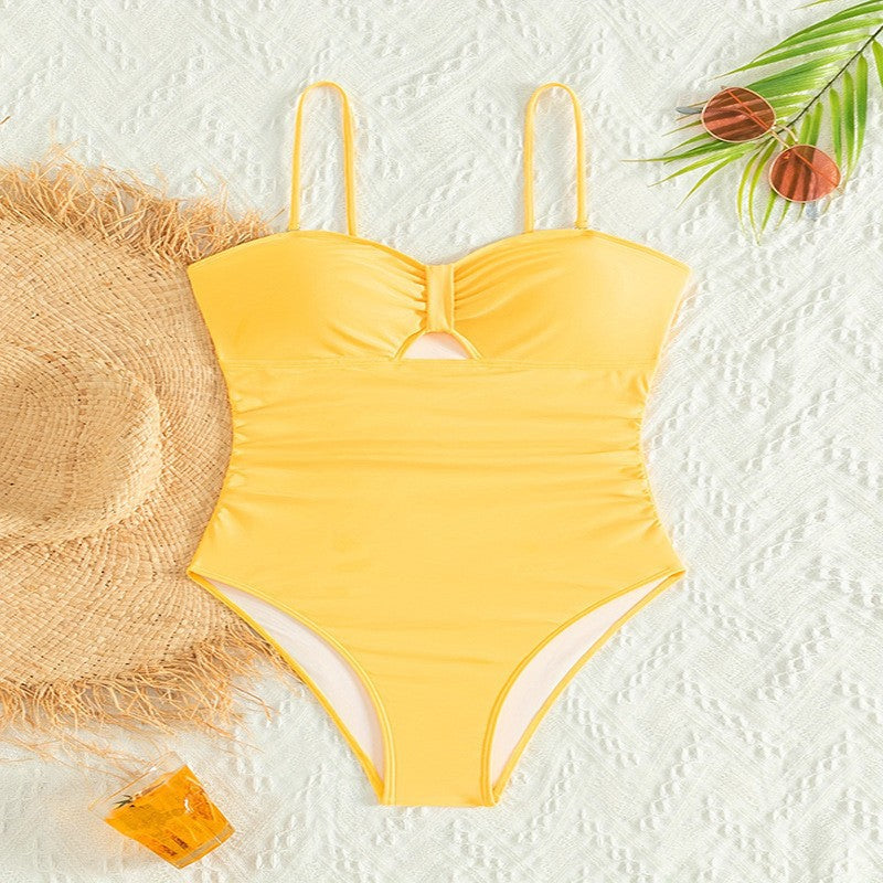 Women's one-piece swimsuit with sophisticated cut-out and gathering.