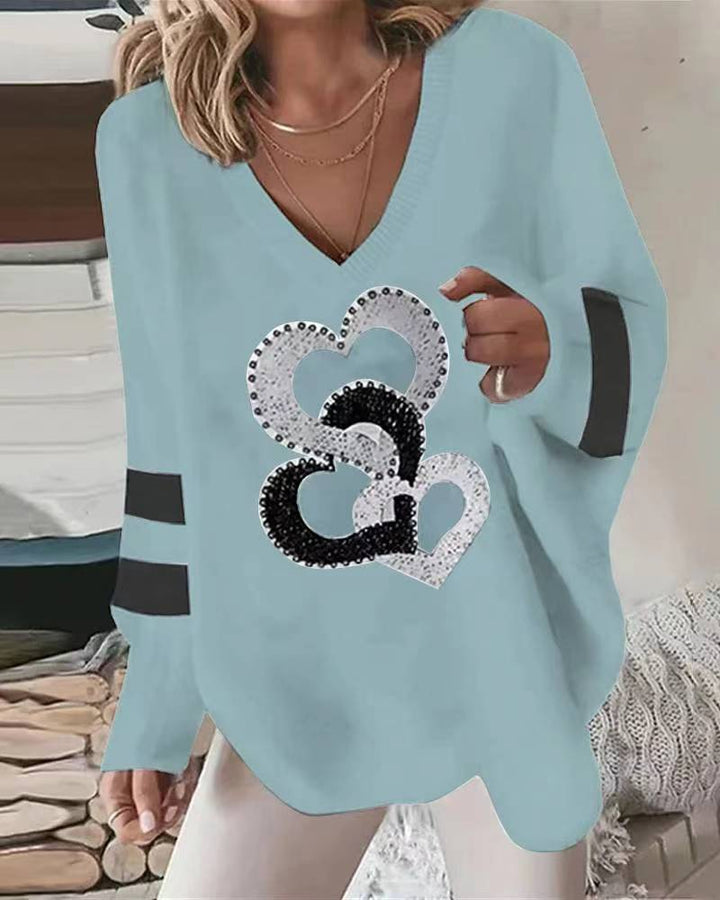 Women's oversized knitted sweater with deep neckline sequin heart and contrast sleeve stripes StylebySassy