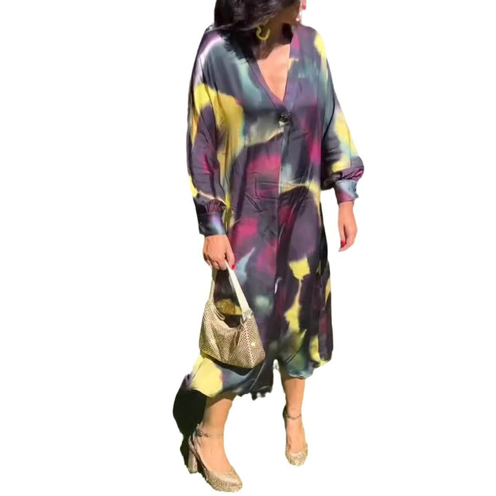 Women's flowing midi dress with abstract print, V-neckline, balloon sleeves, and decorative closure StylebySassy