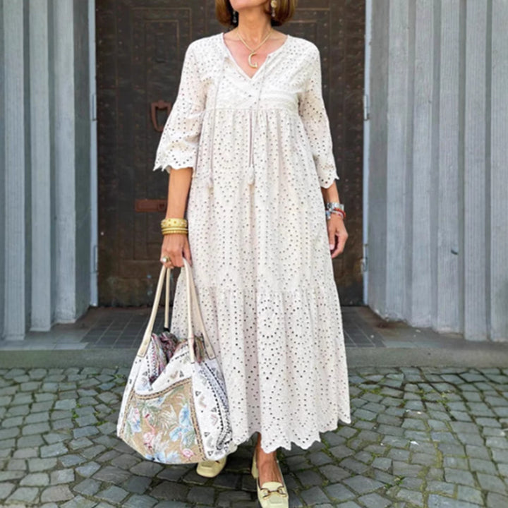 Women's flowing maxi dress with openwork embroidery, V-neck, underbust seam, and ruffled skirt StylebySassy