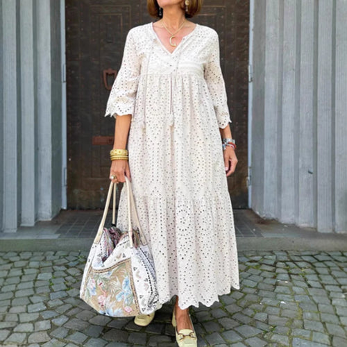Women's flowing maxi dress with openwork embroidery, V-neck, underbust seam, and ruffled skirt StylebySassy