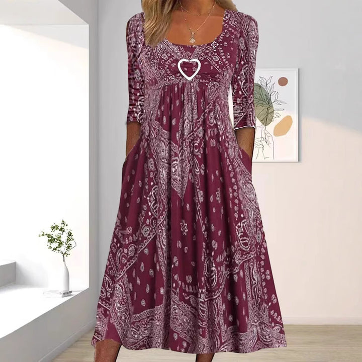 Women's maxi dress with paisley bandana pattern, empire seam, gathered underbust area, and side pockets StylebySassy