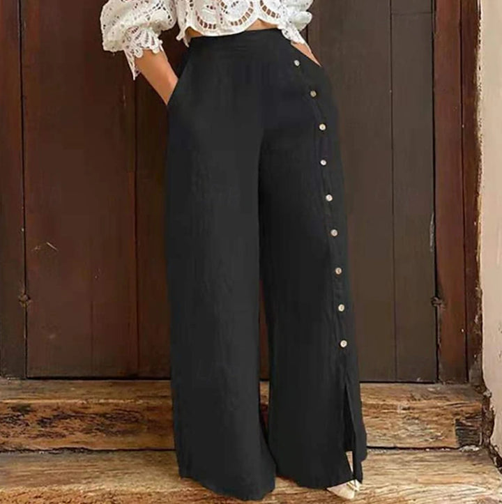 Women's high-waisted linen trousers with a side decorative button placket, side pockets, and wide leg cut StylebySassy