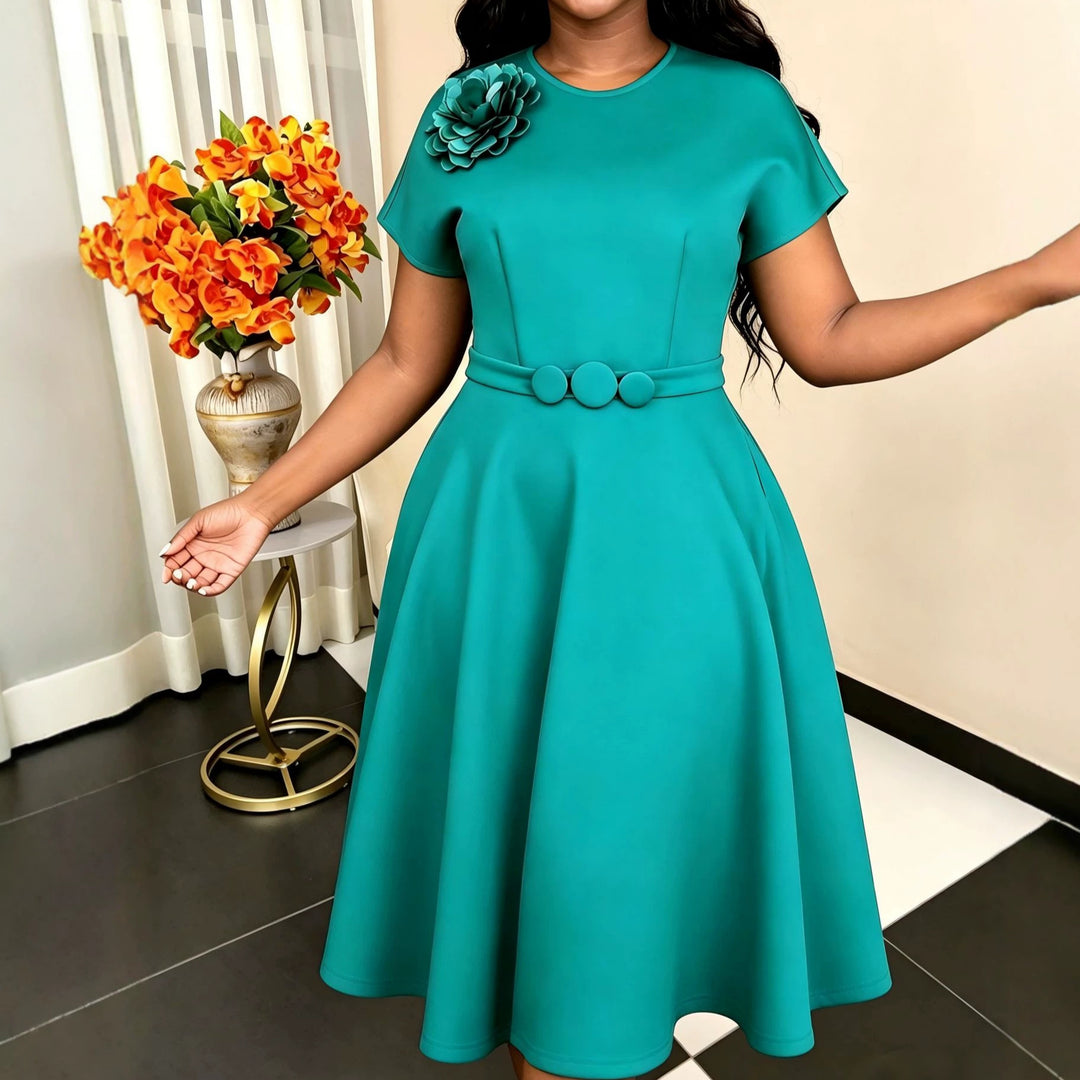 Women's dress with elegant belt and decorative flower accent StylebySassy