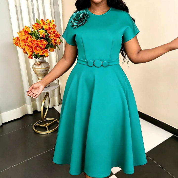 Women's dress with elegant belt and decorative flower accent StylebySassy
