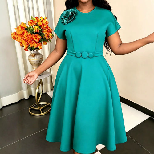 Women's dress with elegant belt and decorative flower accent StylebySassy