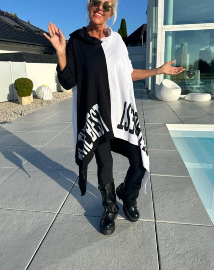 Women’s long-cut hooded poncho with asymmetric pointed hem and large statement print StylebySassy