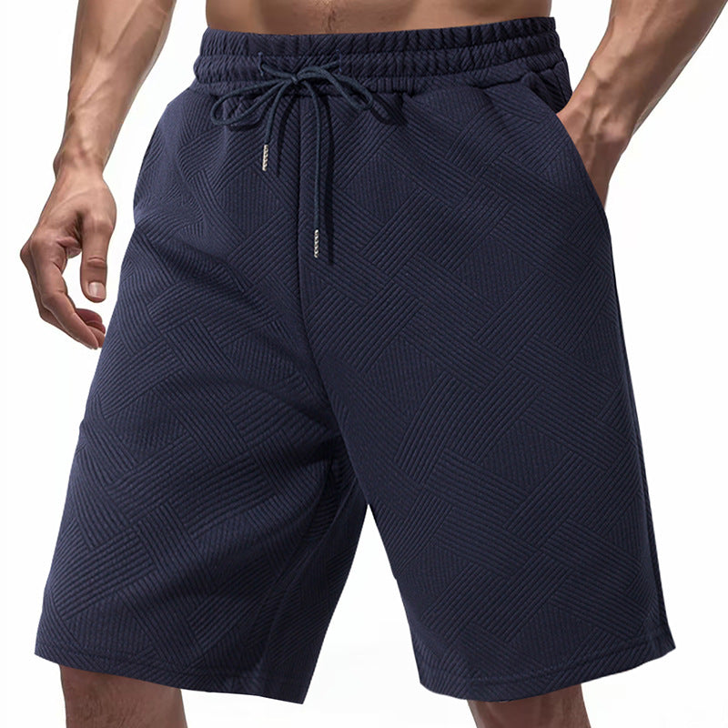 Men's knee-length textured swim shorts with elastic drawstring waistband and side pockets StylebySassy