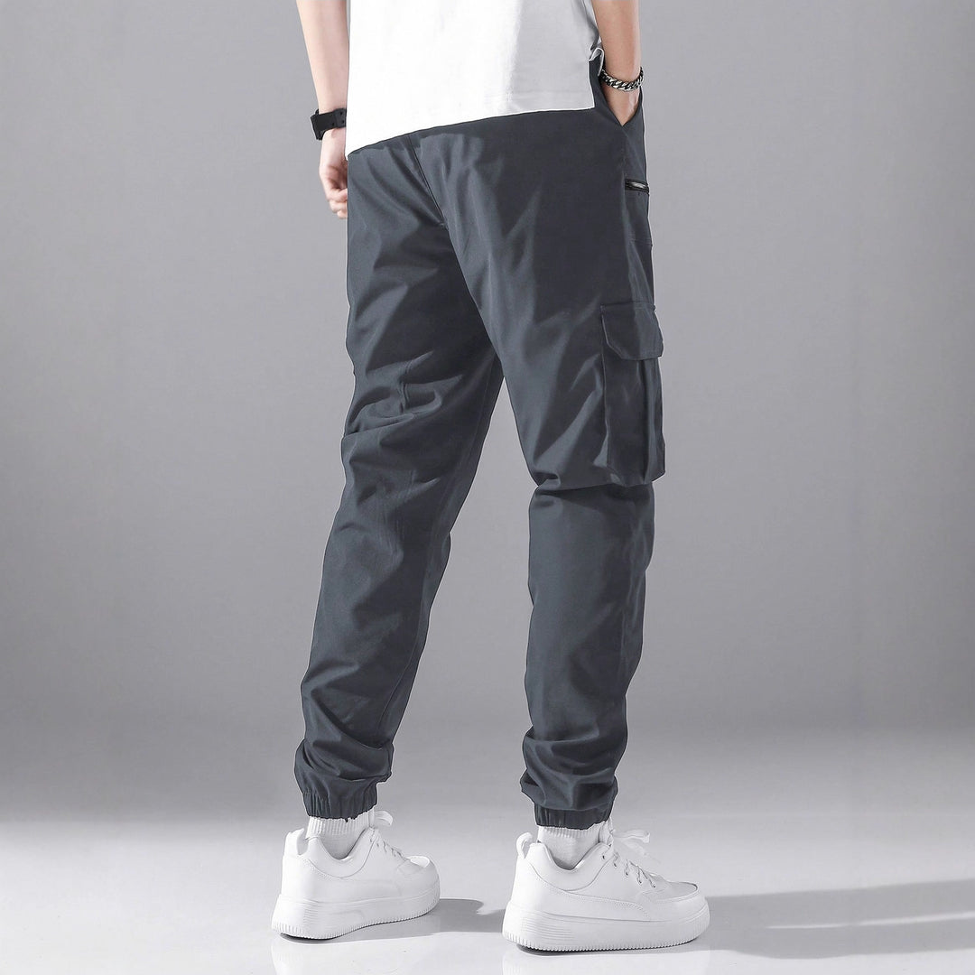 Men's slim cargo joggers with multiple zippered pockets, elastic ankle cuff, and drawstring StylebySassy
