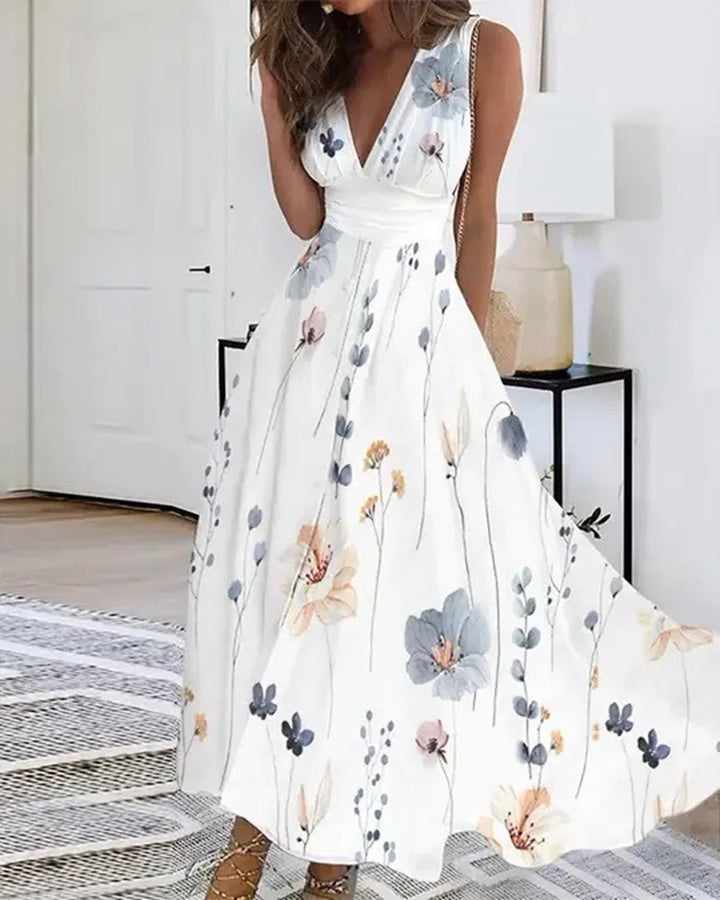 Women's flared midi dress with deep V-neck, empire waist and delicate floral print StylebySassy
