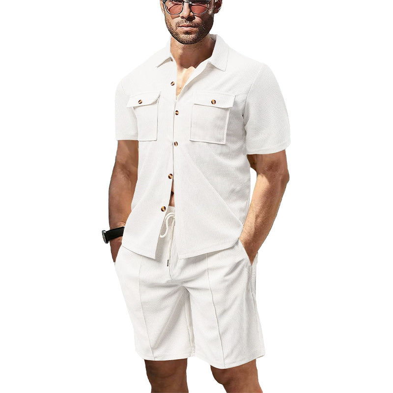 Men's modern short-sleeve shirt set in resort style with patch pockets, open lapel collar, and drawstring Bermuda shorts made of textured jersey StylebySassy