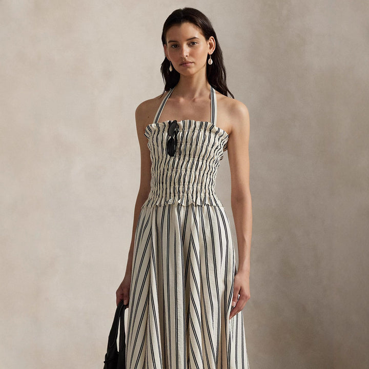 Women's midi dress with smocked bodice, adjustable halter strap, wide A-line skirt and side pockets StylebySassy