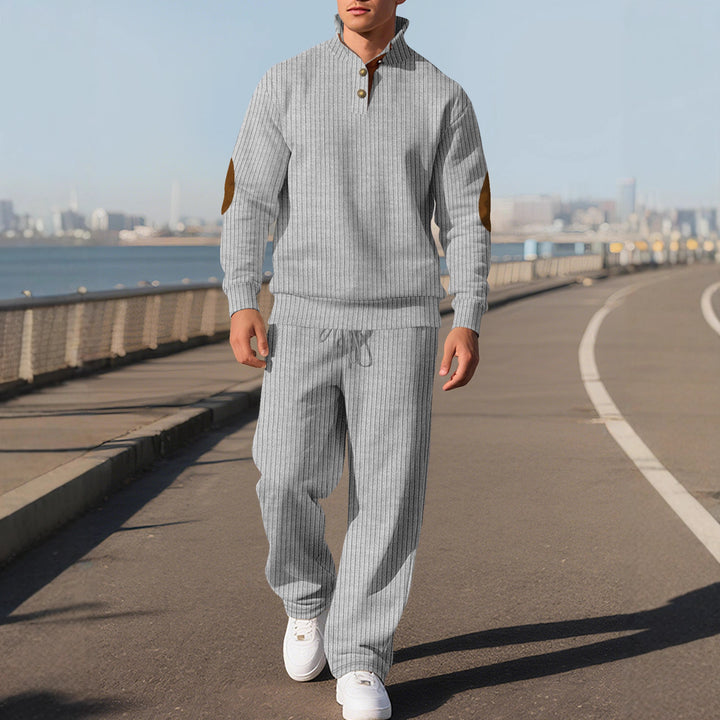 Men's fine ribbed sweater with half button placket, high stand-up collar, and contrasting suede elbow patches StylebySassy