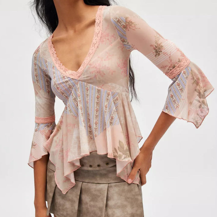 Ladies sheer mesh top with V-neck, lace trim, asymmetric ruffle hem, and bell sleeves StylebySassy