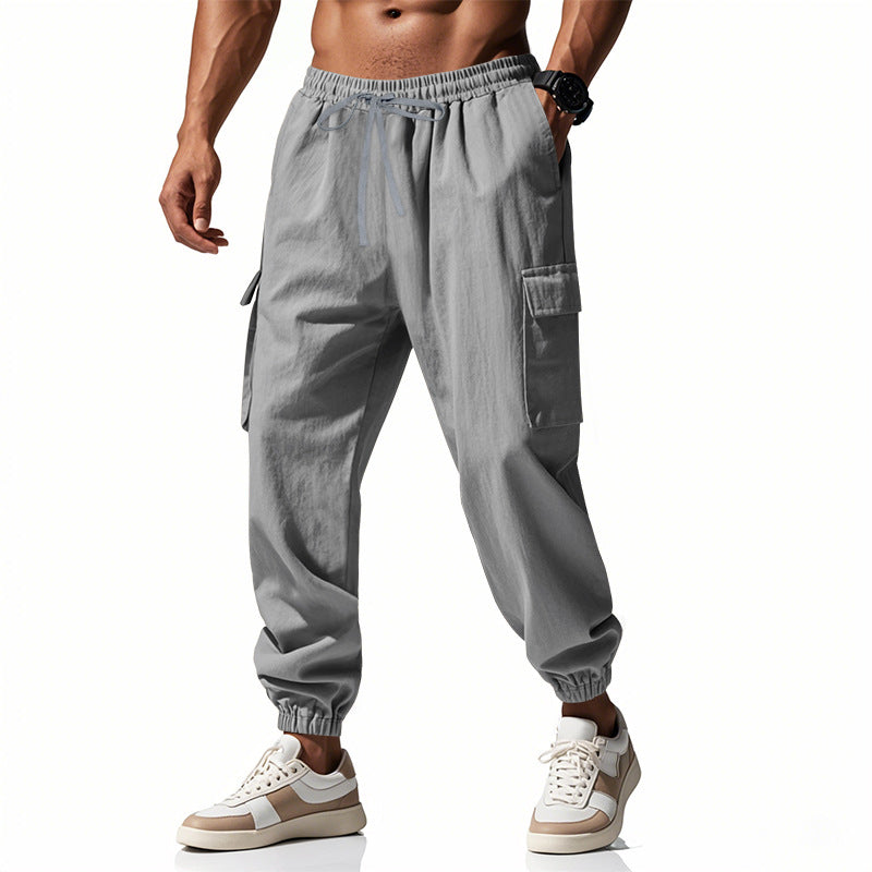 Men's tapered joggers in utilitarian style with elastic waistband, drawstring, and flap pockets StylebySassy