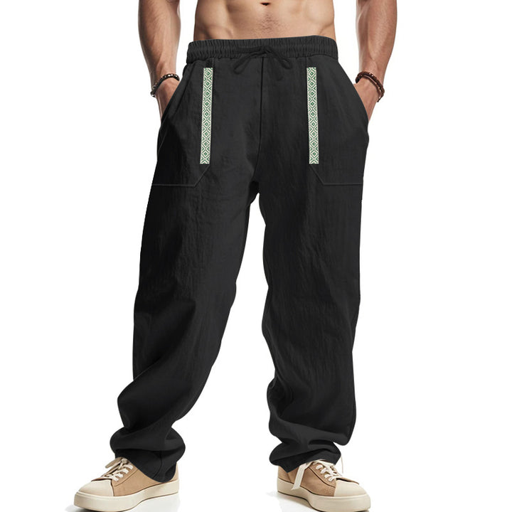 Men's loose-fitting casual pants made of linen blend with elastic waistband, deep side pockets, and ethnic decorative band StylebySassy