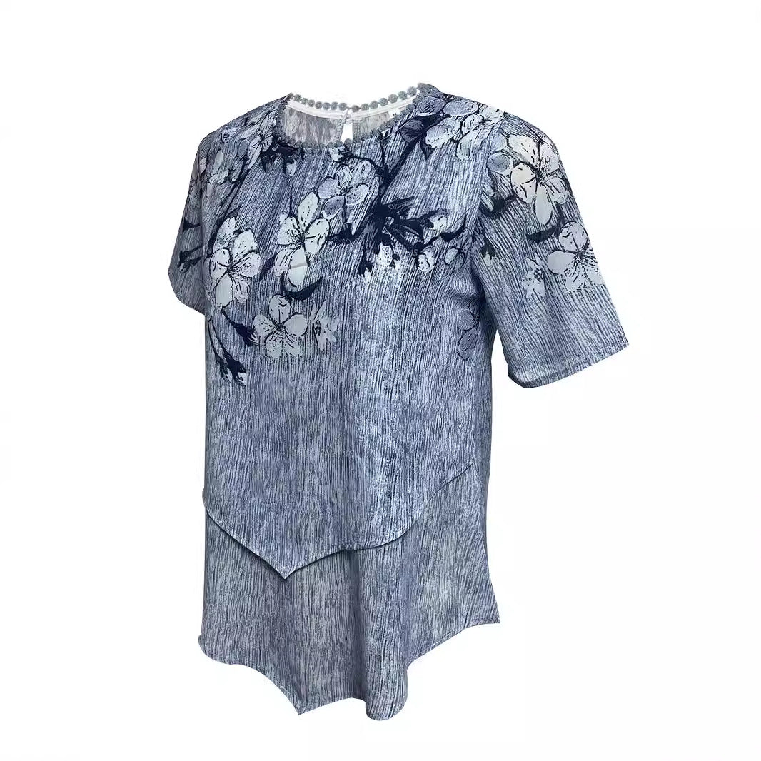 Women's two-layer blouse dress with asymmetrical tiered hem, floral print yoke, and wing sleeves StylebySassy