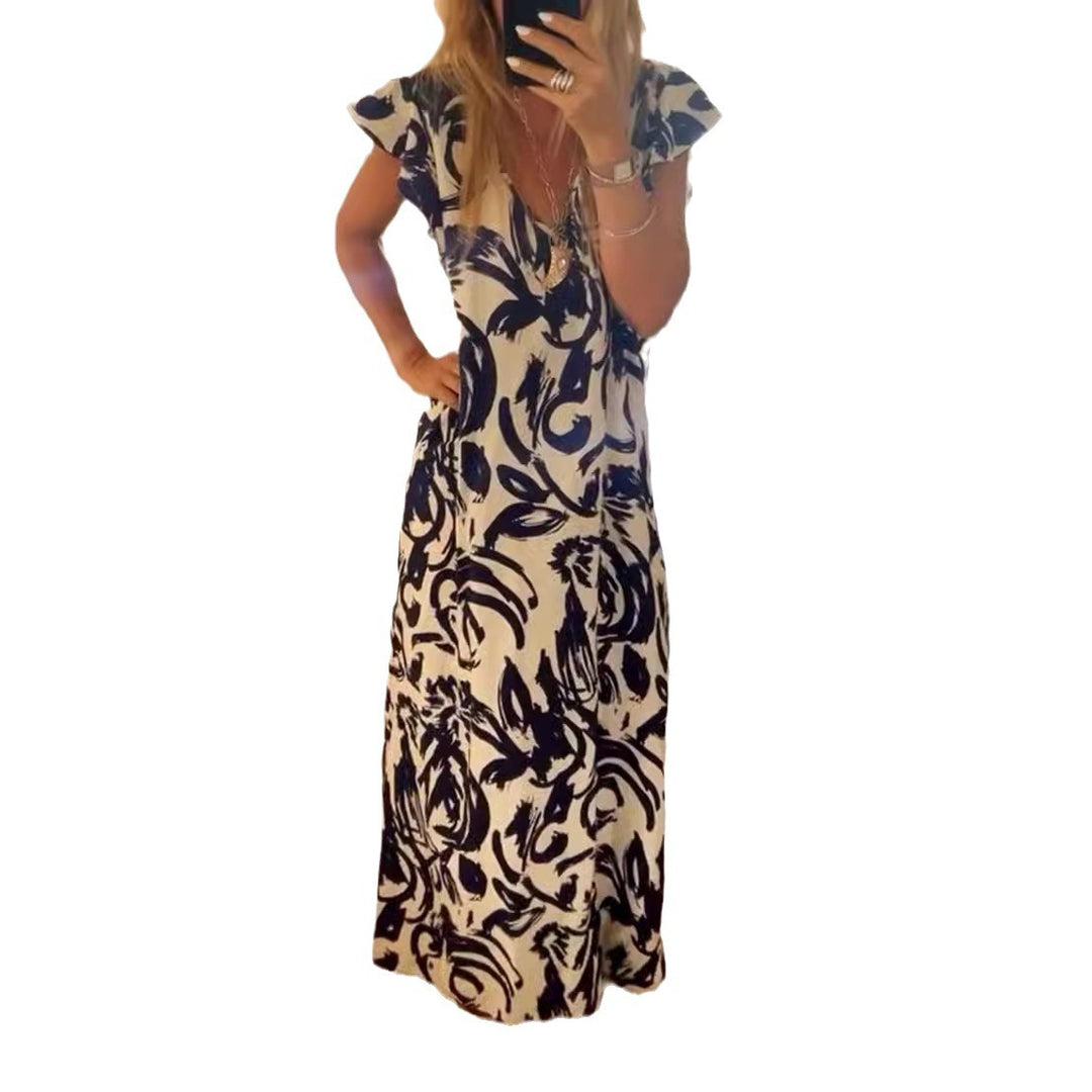 Women's flowing maxi dress with V-neck, flutter sleeves, and side leg slit StylebySassy