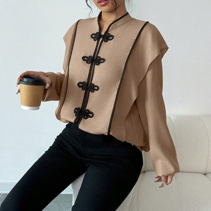 Women's stand-up collar blouse with decorative knot closures and decorative piping StylebySassy