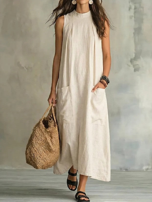Women’s sleeveless linen maxi dress with standing collar, pleats at the chest, and piled pockets StylebySassy