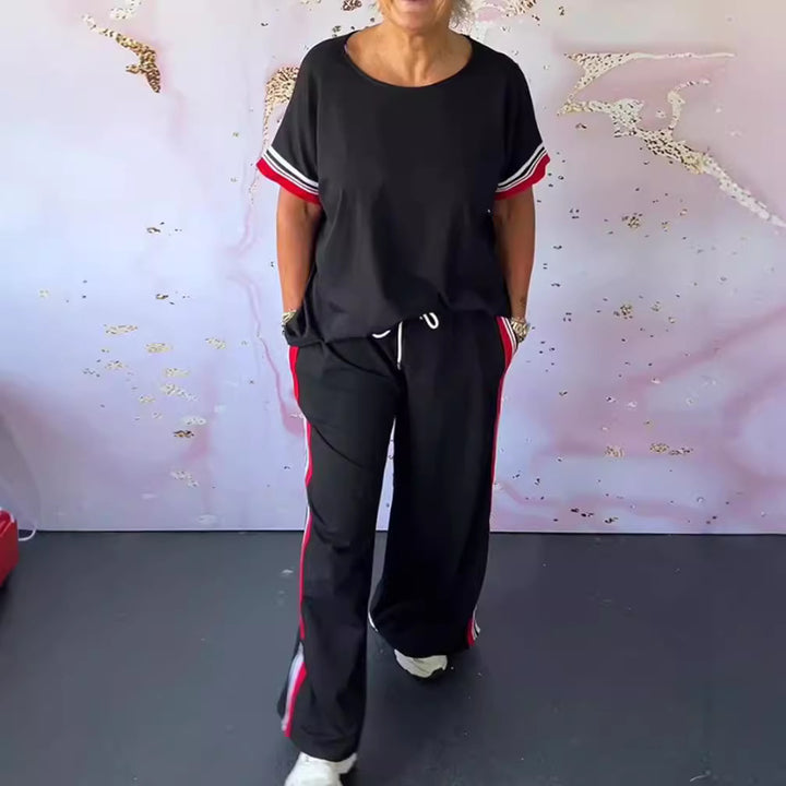 Ladies' sporty-elegant two-piece set with boxy short sleeve shirt, drawstring jog pants, and side contrast stripe StylebySassy
