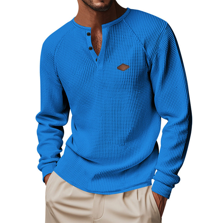 Men's structured long-sleeve shirt with short button placket, raglan sleeves, and subtle logo application StylebySassy