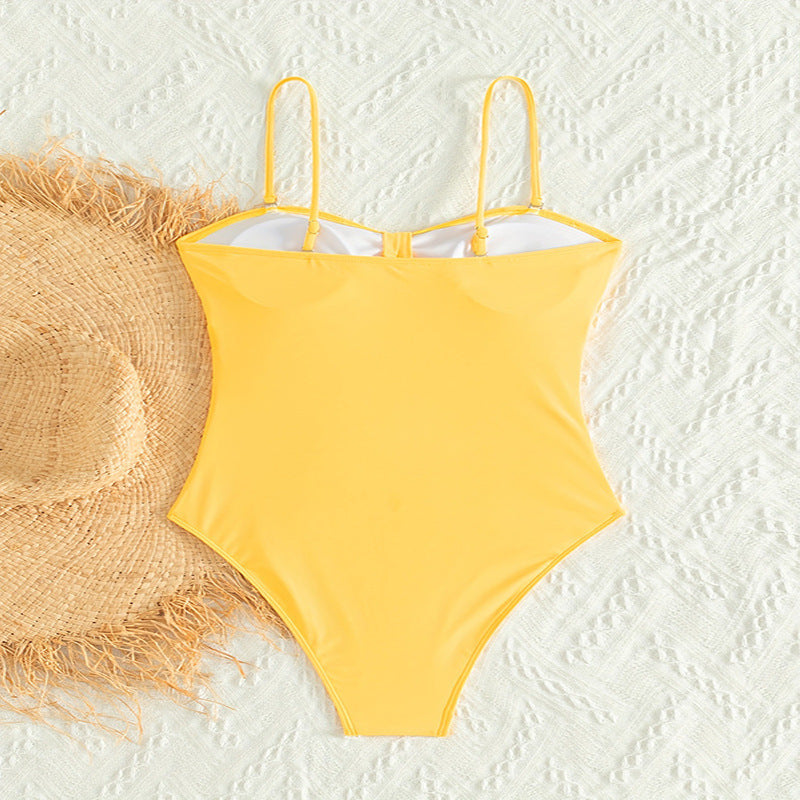 Women's one-piece swimsuit with sophisticated cut-out and gathering.
