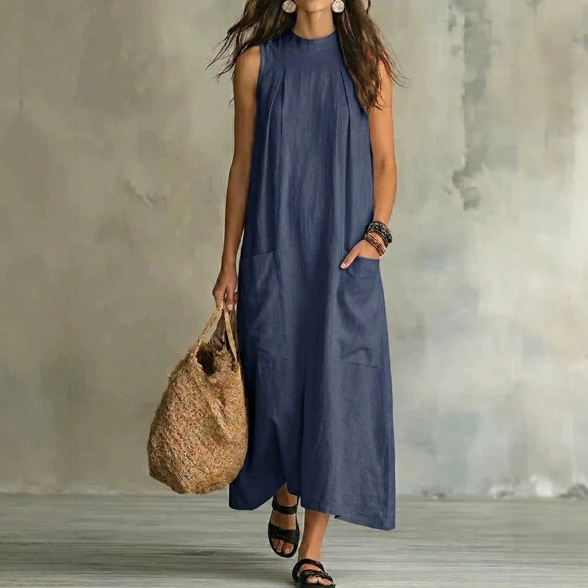 Women’s sleeveless linen maxi dress with standing collar, pleats at the chest, and piled pockets StylebySassy