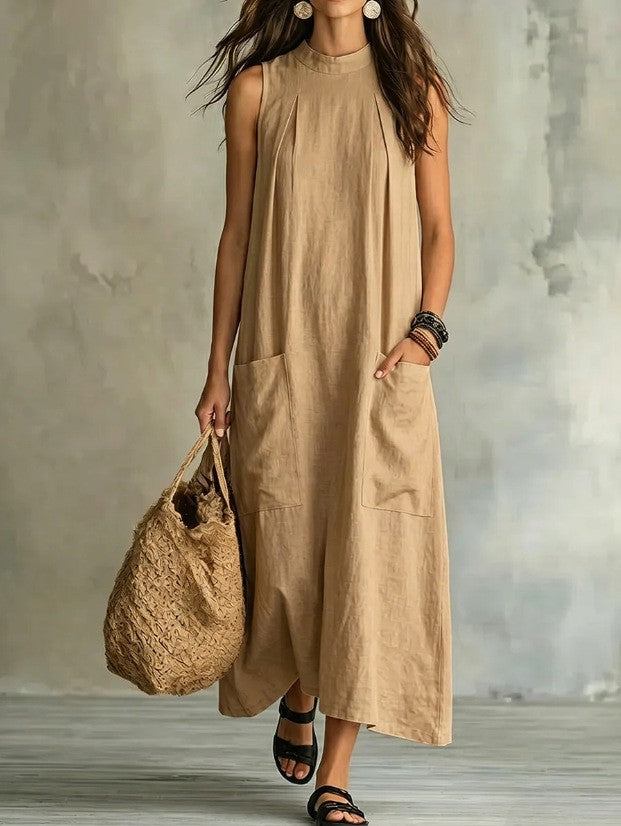 Women’s sleeveless linen maxi dress with standing collar, pleats at the chest, and piled pockets StylebySassy