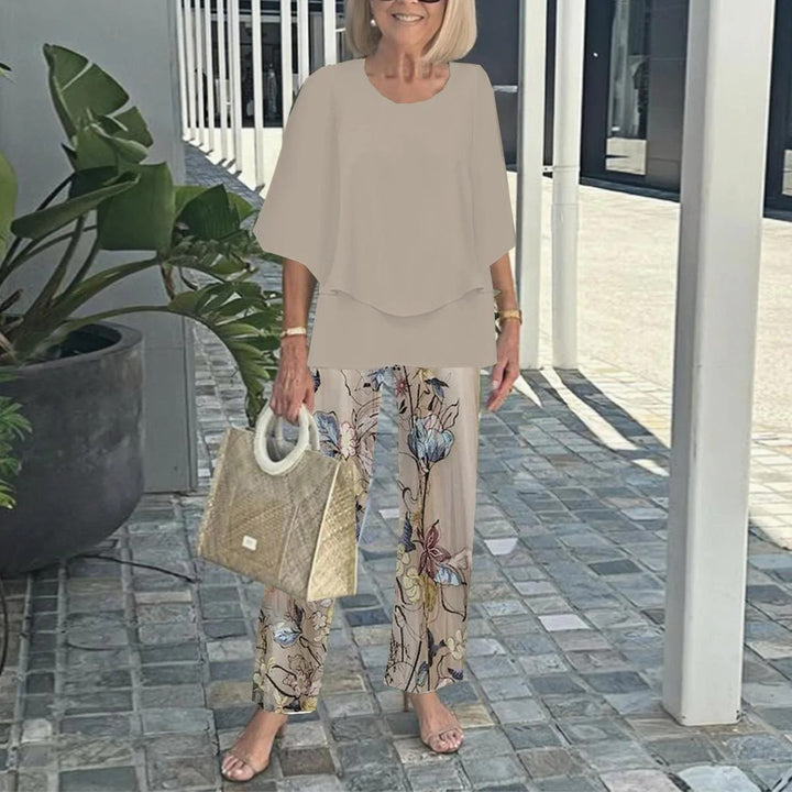 Women's layered tunic with cape sleeves and ankle-length straight leg pants with graphic print StylebySassy