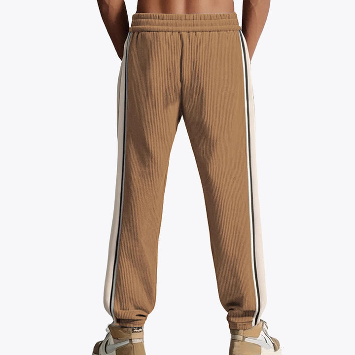 Men's loose training pants in corduroy look with drawstring waistband and side contrast stripes StylebySassy