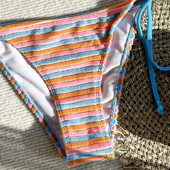 Women's bikini model with playful striped pattern StylebySassy