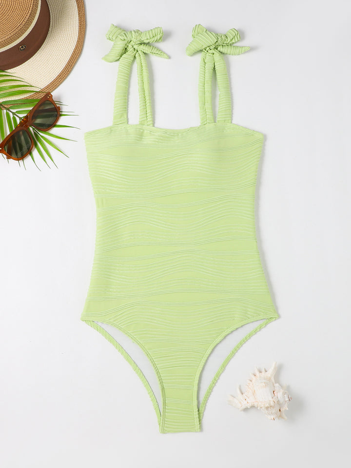 Women's figure-fitting one-piece swimsuit with playful bow details StylebySassy