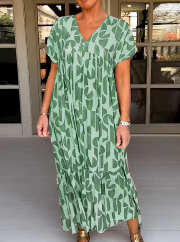 Women's voluminous maxi dress with under-bust seam, V-neck, short kimono sleeves, and tiered ruffle StylebySassy