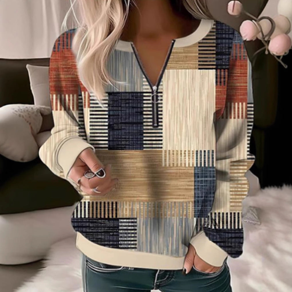 Women's cozy sweater with short zip, graphic patchwork pattern, extended sleeve cuffs, and ribbed hem StylebySassy